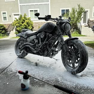 Motorcycle covered in soap suds during a wash