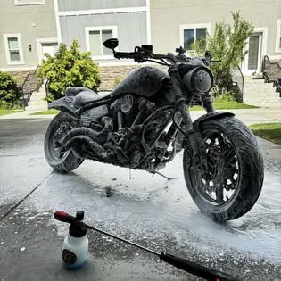 Motorcycle covered in soap suds during a wash