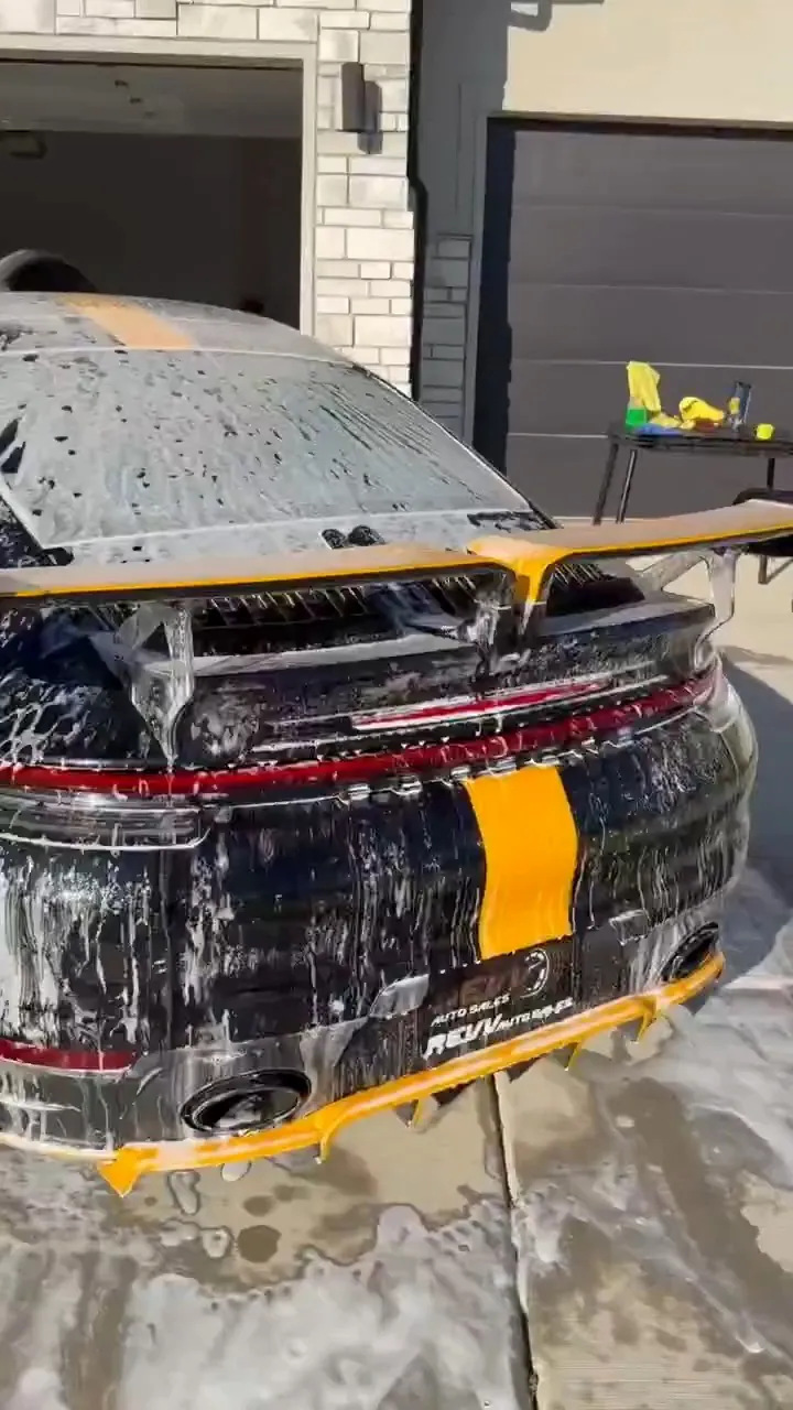 Soap-covered Porsche rear wing and bumper during a hand wash