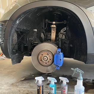 Wheel well and brake caliper detail with cleaning products